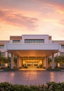 Example ad, a hotel entrance at dawn under a covered porch
