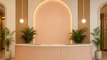 Example landing page picture, a hotel lobby with a curved front desk